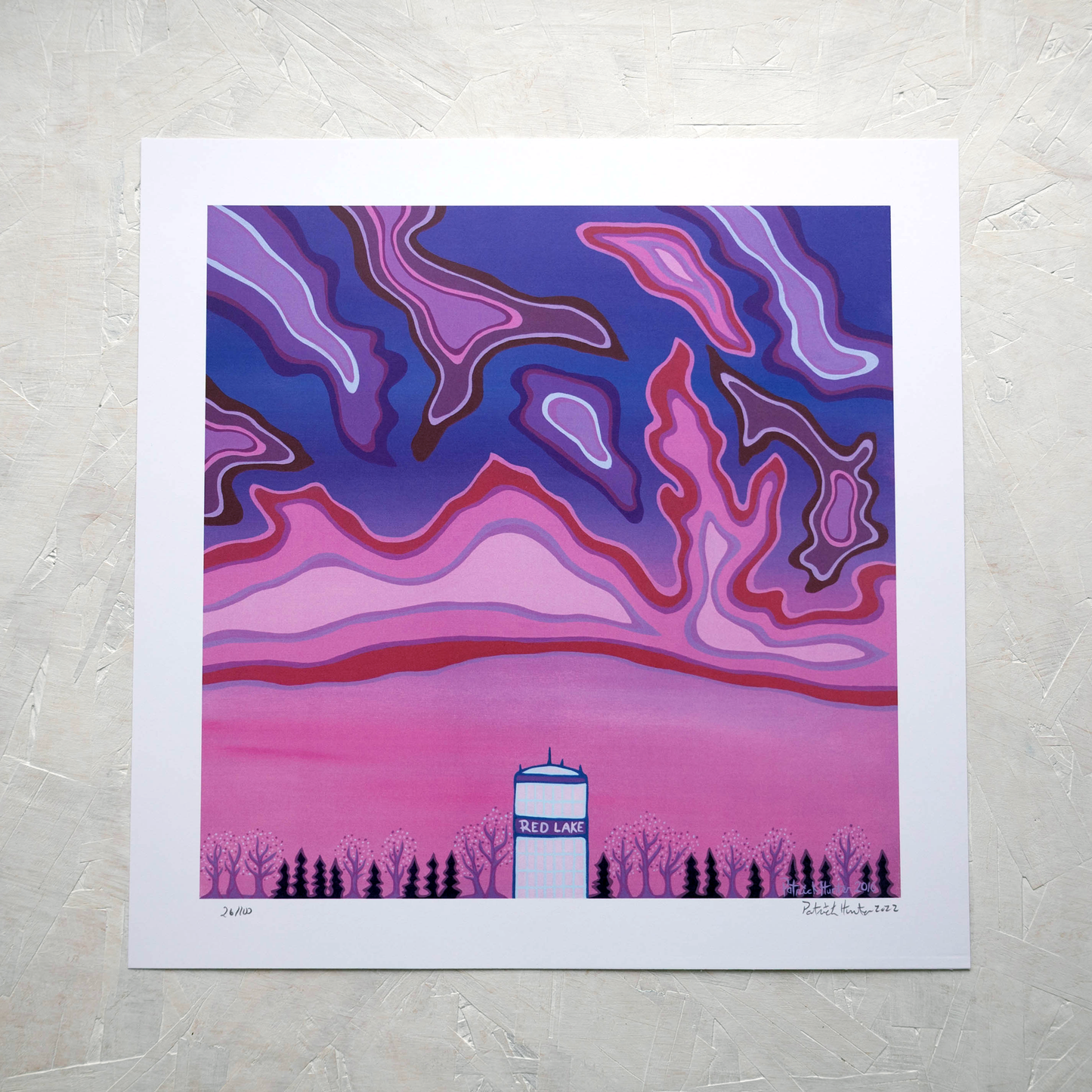 Print of Patrick Hunter's painting of a water tower, with text Red Lake, against a vibrant background of pinks and purples, woodland art style.