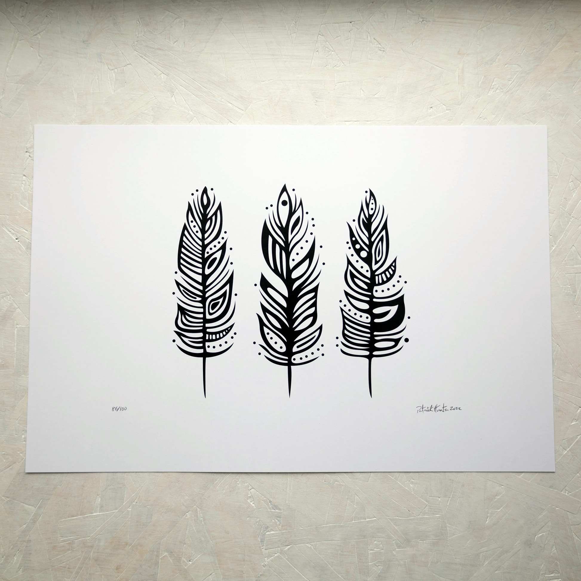 Print of Patrick Hunter's painting of three feathers, black on white, woodland art style.