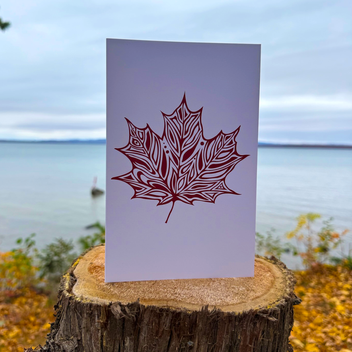 A greeting card with Patrick's woodland style maple leaf in red.