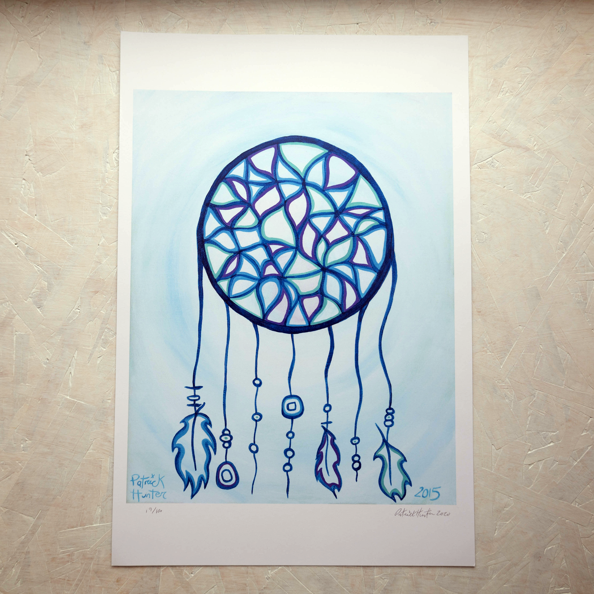 Print of Patrick Hunter's painting of a dreamcatcher in blues and purples on light blue background in woodland art style.