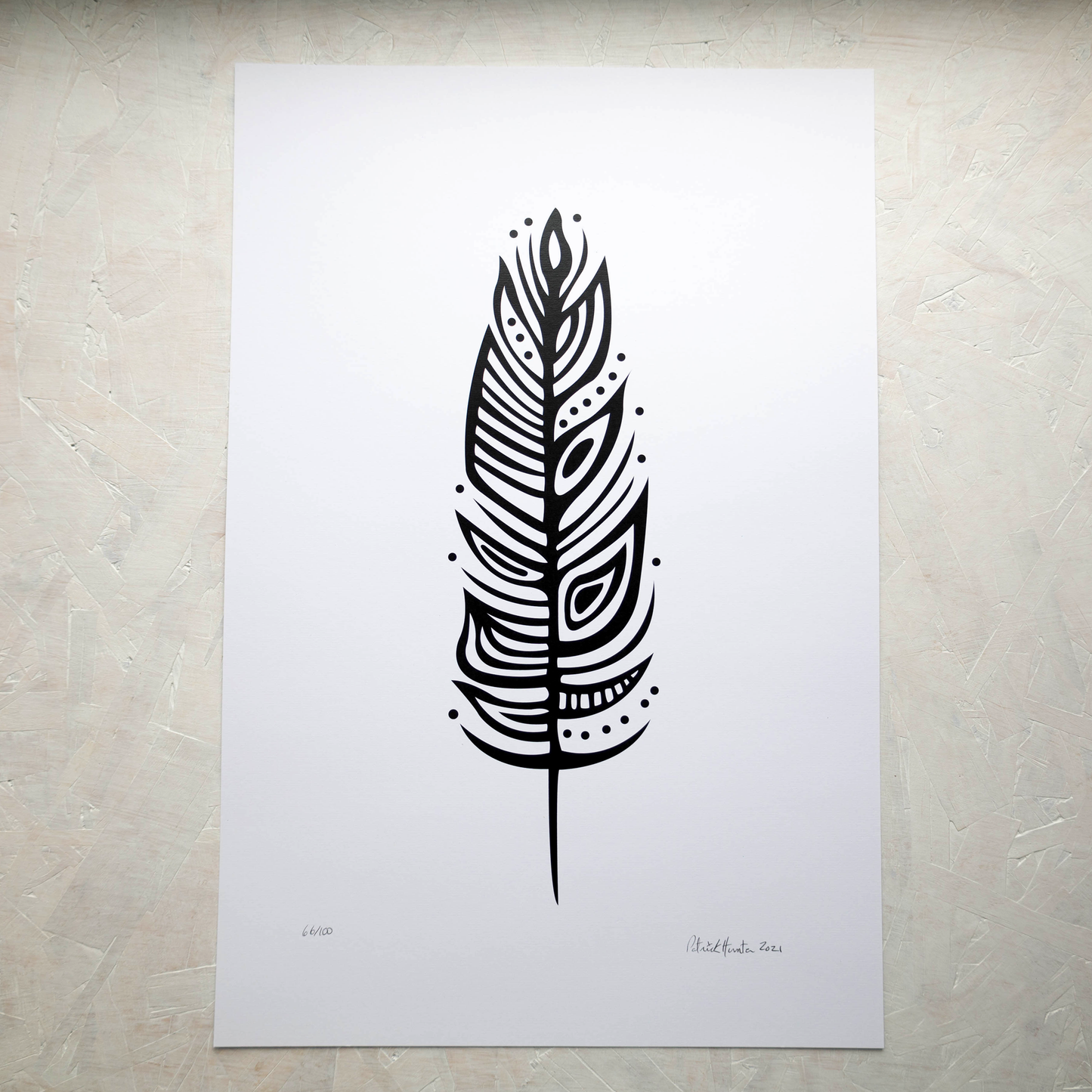 Print of Patrick Hunter's painting of an eagle feather in black on white, woodland art style.