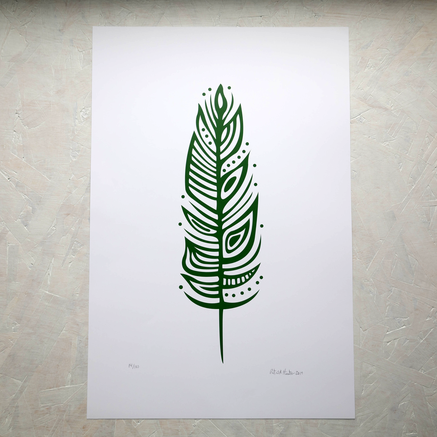 Print of Patrick Hunter's painting of an eagle feather in green on white, woodland art style.