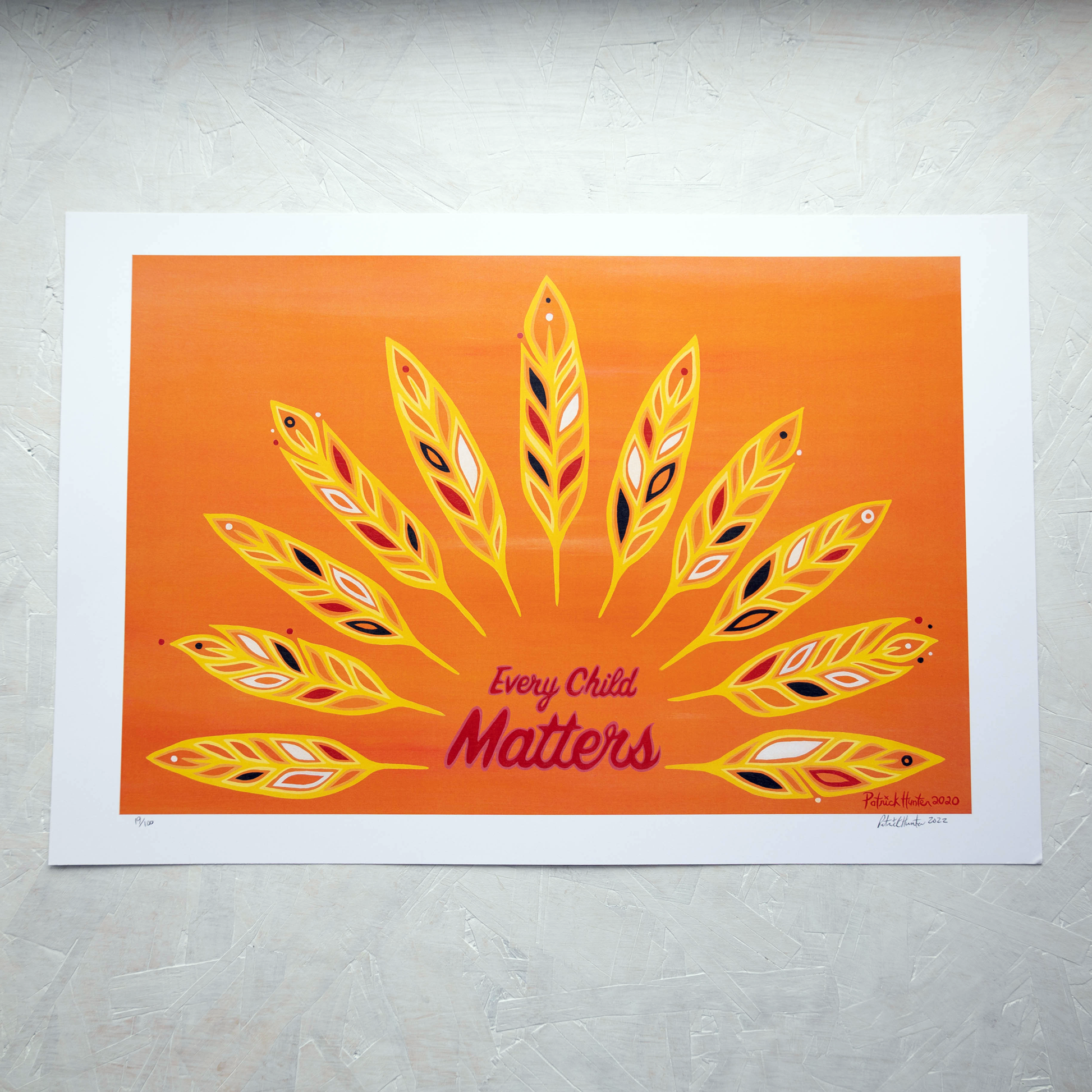 Print of Patrick Hunter's painting of feathers on an orange background radiating out from text that reads Every Child Matters, woodland art style.