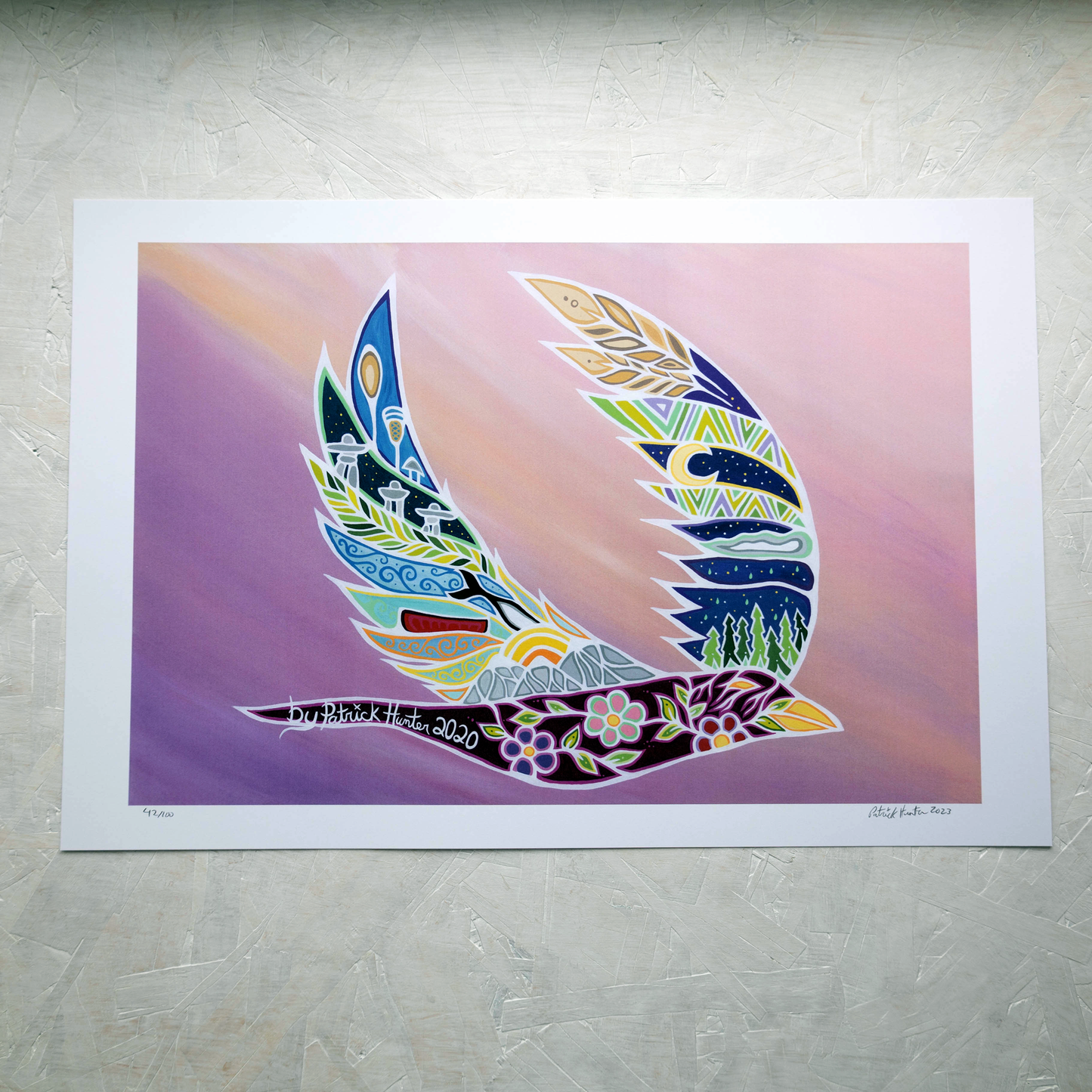 Print of Patrick Hunter's painting of a bird in flight with various landscapes and cultural icons in the wings, in woodland art style.
