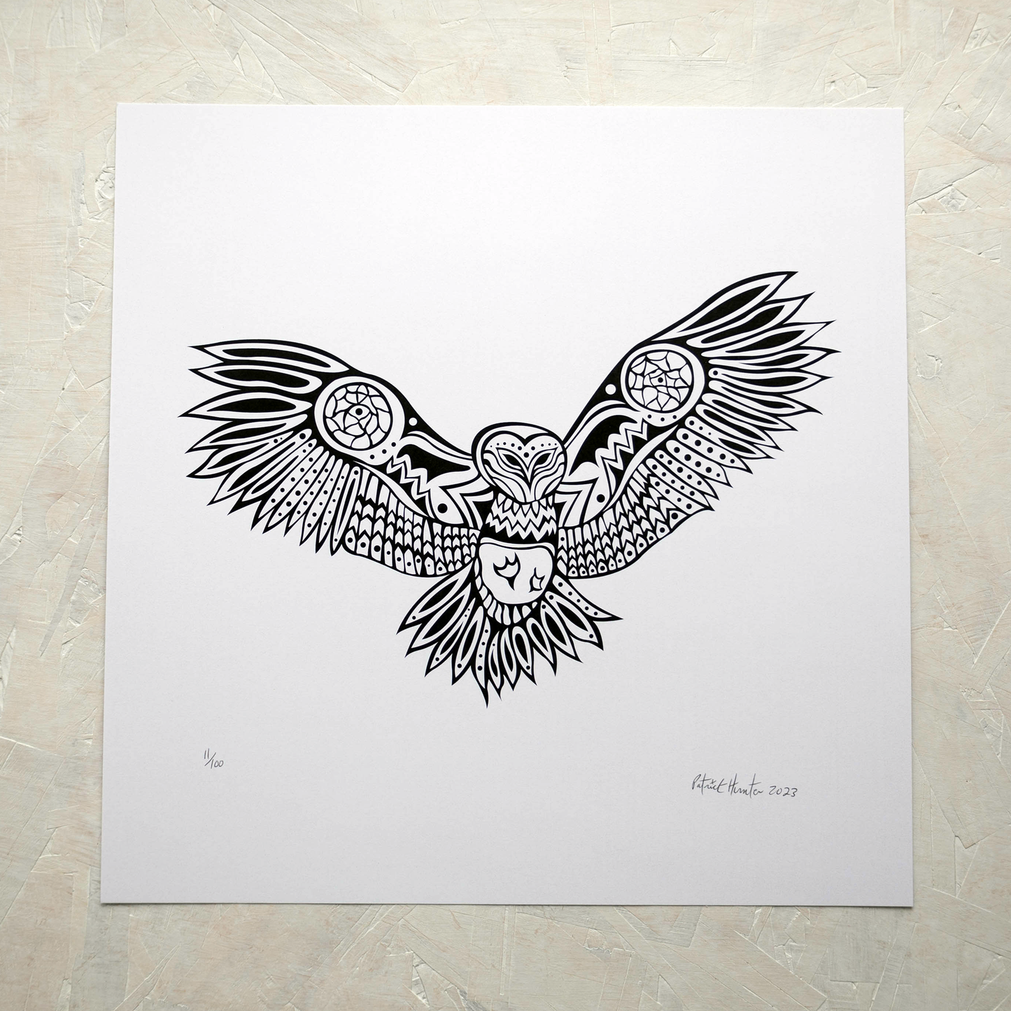 Print of Patrick Hunter's painting of an owl with outstretched wings in black on white, woodland art style.