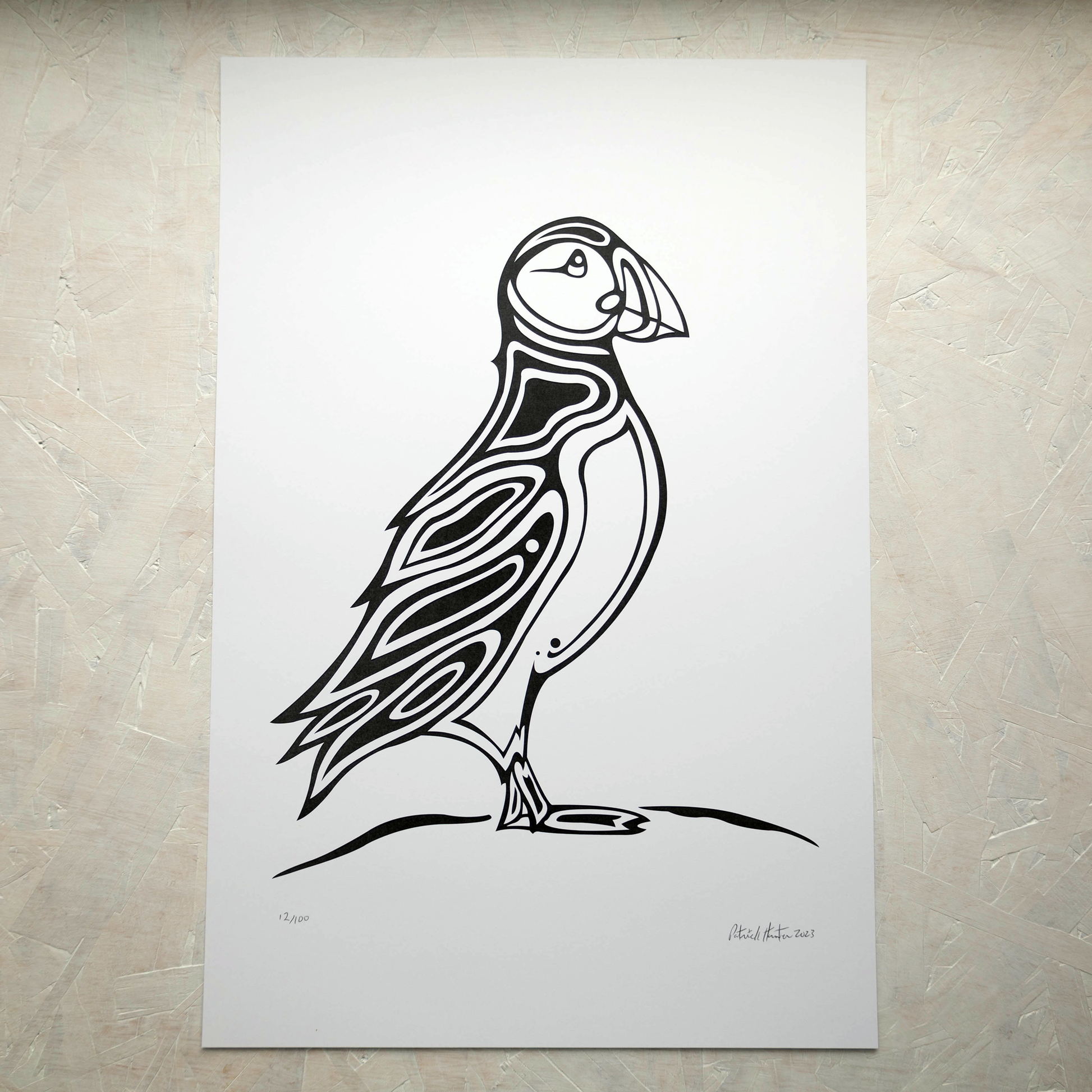 Print of Patrick Hunter's painting of a puffin, black on white, woodland art style.