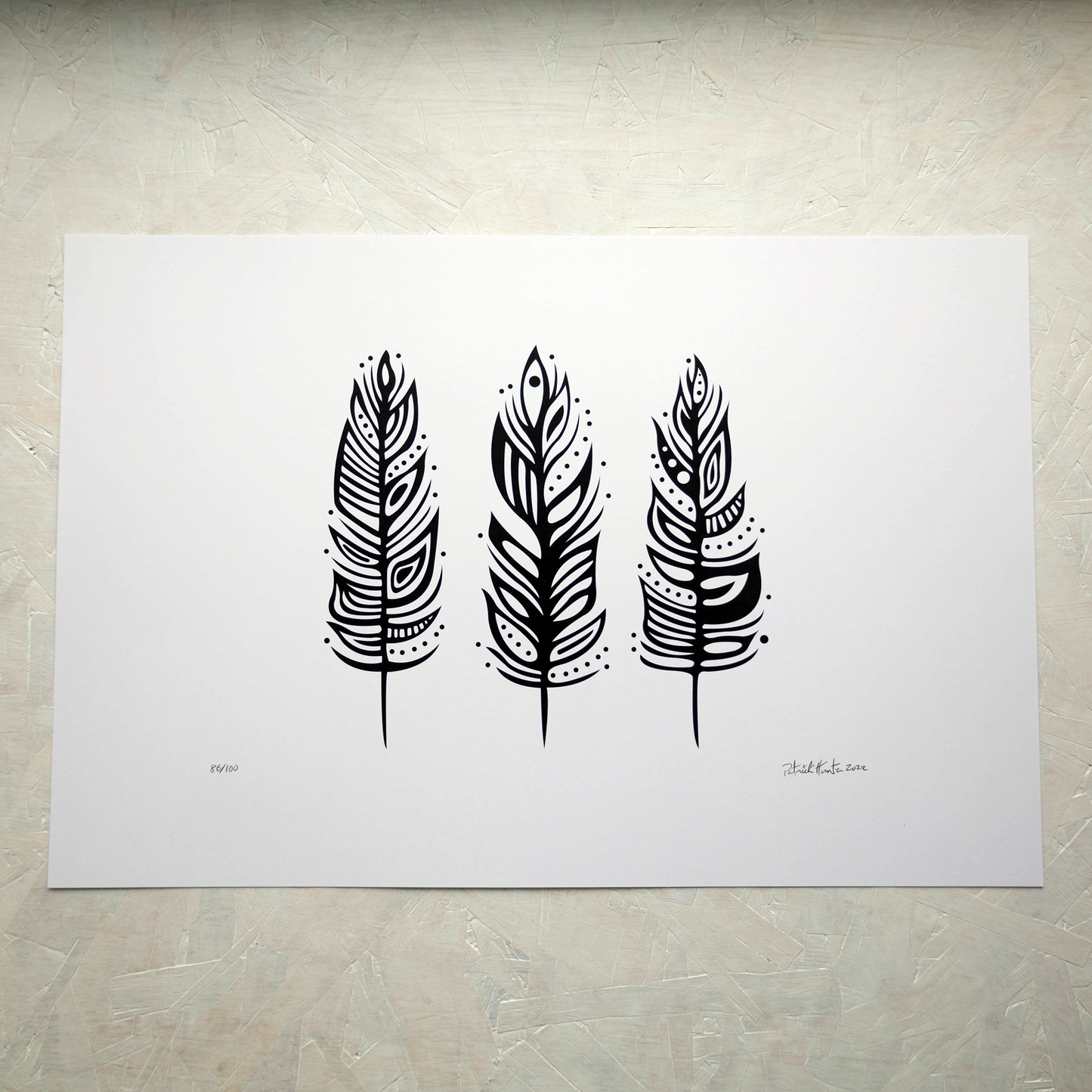 Print of Patrick Hunter's painting of three feathers, black on white, woodland art style.