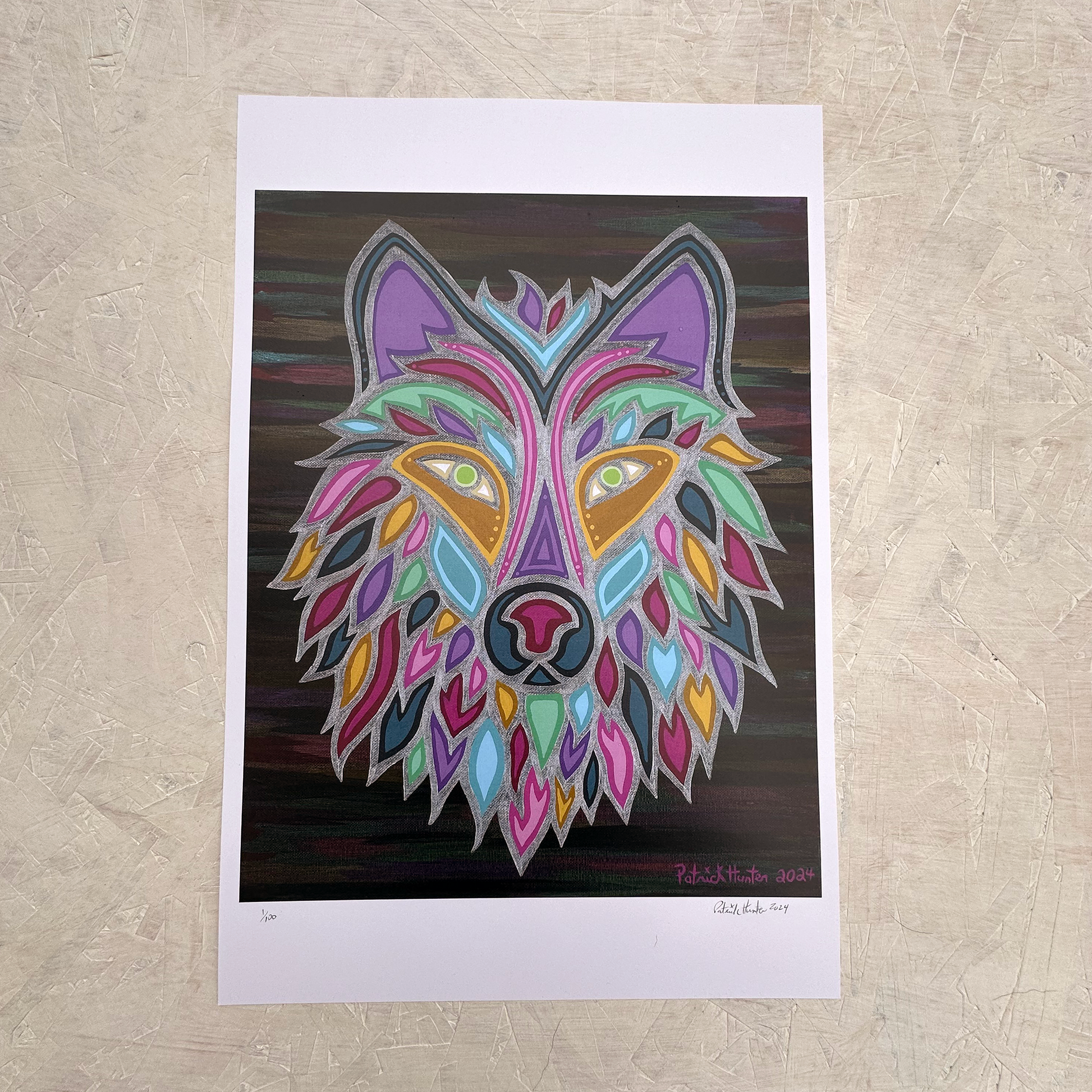 Print of Patrick Hunter's painting, Wolf Mother, consisting of a portrait of a multi-coloured wolf on a dark varigated background with silver elements.