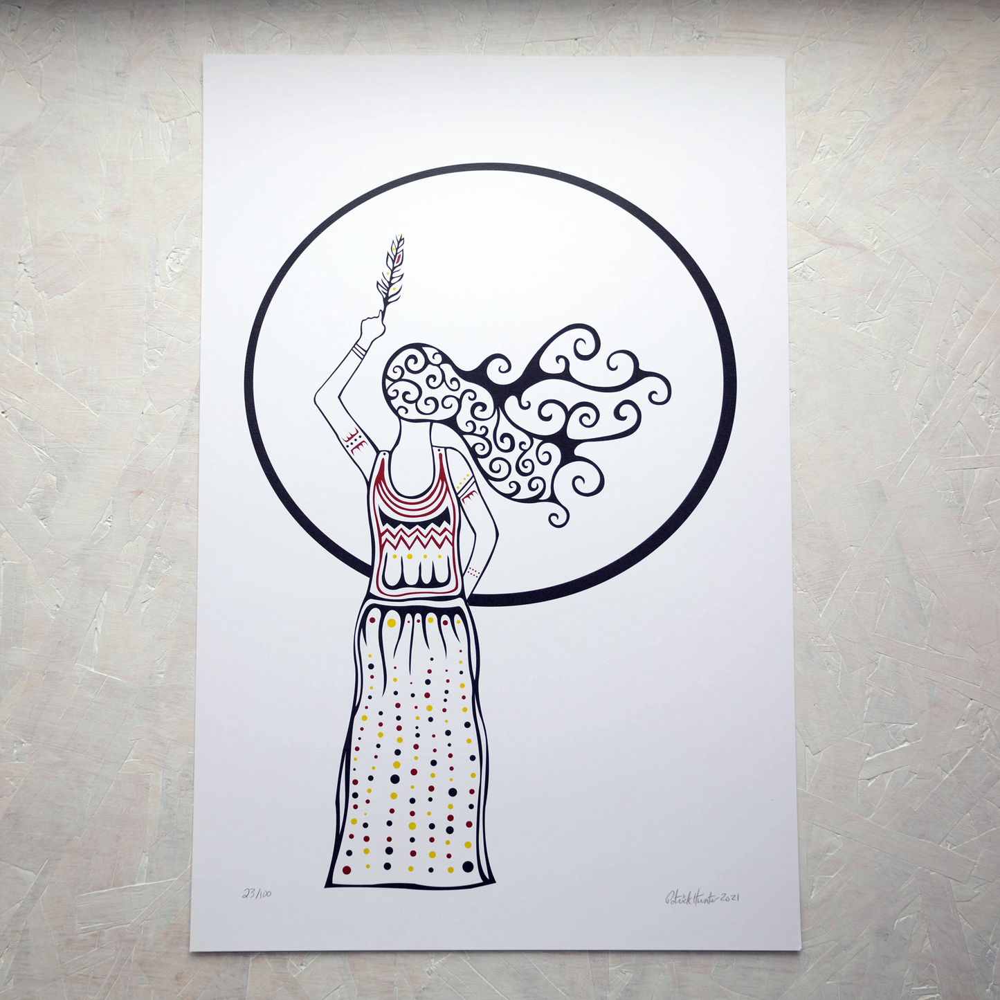 Print of Patrick Hunter's painting of a woman raising a feather up in front of a full moon, simplified black on white with some colour highlights, woodland art style.