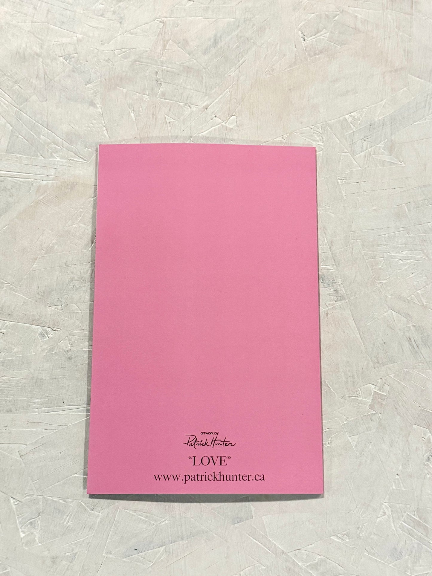 Bubble-gum pink, back of the card with Patrick Hunter logo, the title "LOVE" and website www.patrickhunter.ca