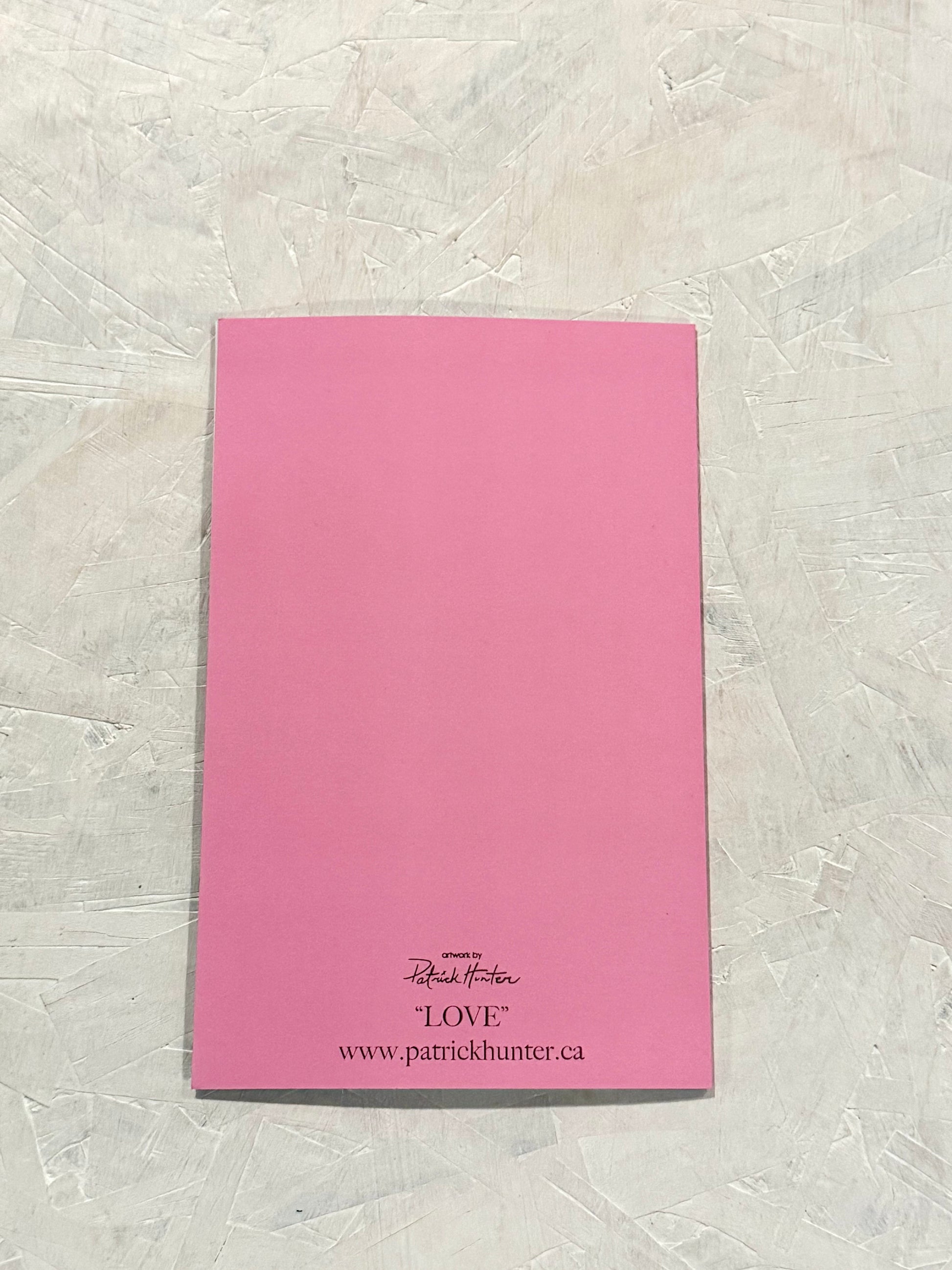 Bubble-gum pink, back of the card with Patrick Hunter logo, the title "LOVE" and website www.patrickhunter.ca