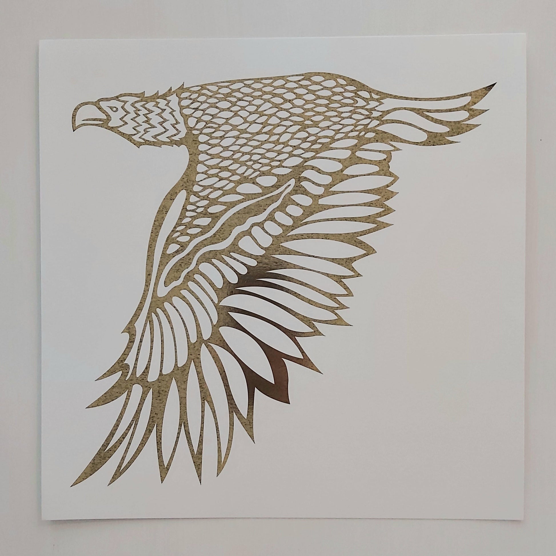 Print of Patrick Hunter's painting of an eagle in flight in gold leaf on white, woodland art style.