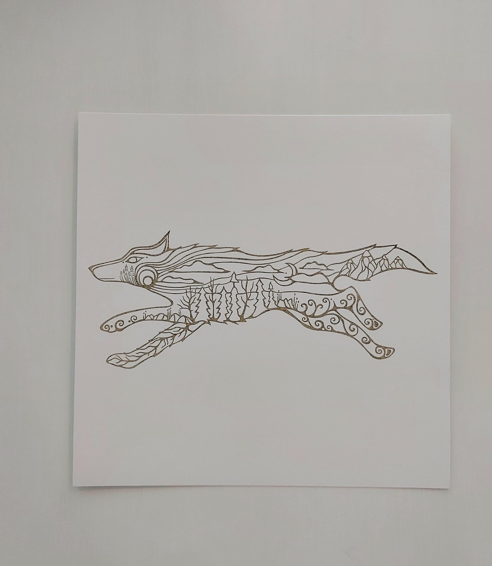Print of Patrick Hunter's painting of a running wolf in woodland art style, gold leaf on white background.
